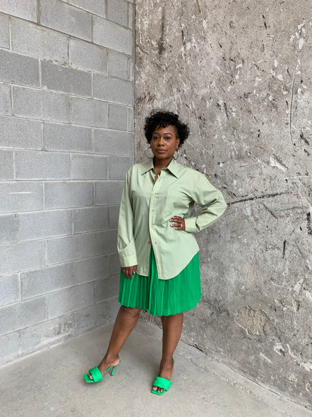 green pleated mini skirt